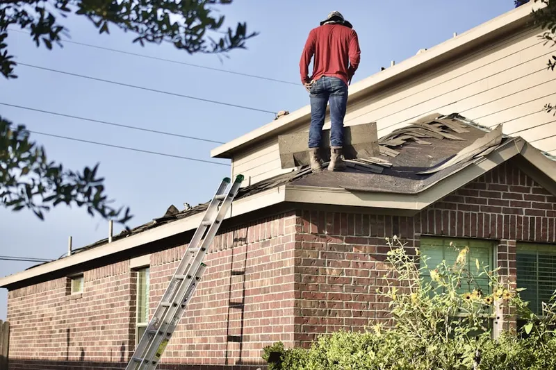 Professional roofer working on a residential roof in Encino